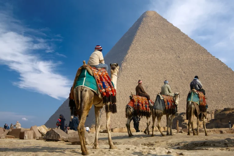 Camel riders at the foot of the Great Pyramid of Giza