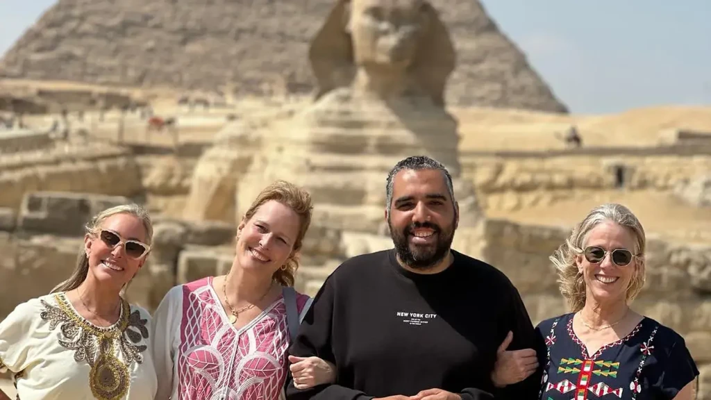 Delta Tours Egypt guests with their guide at the Great Sphinx and the Pyramid of Khafre