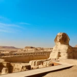 Great Sphinx with a pyramid behind at Giza
