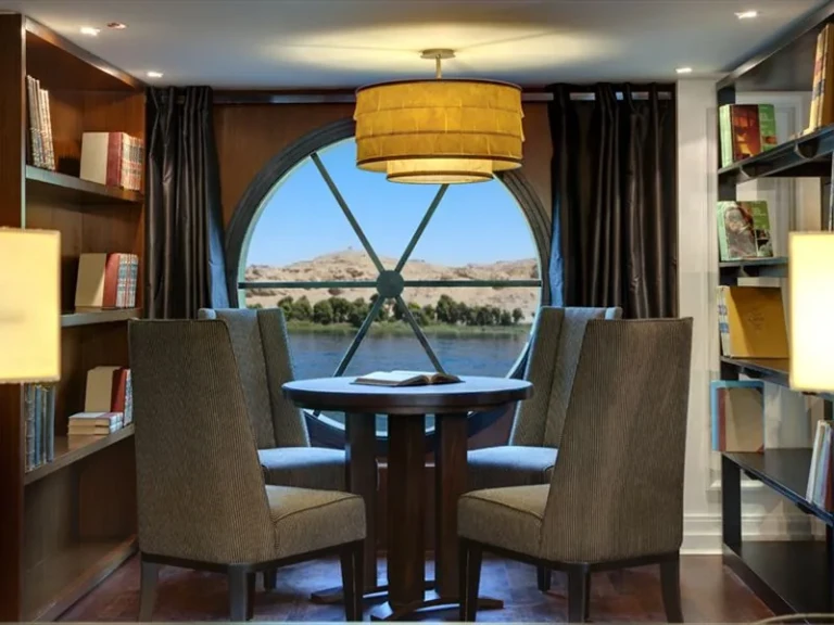 Library corner with round window and armchairs