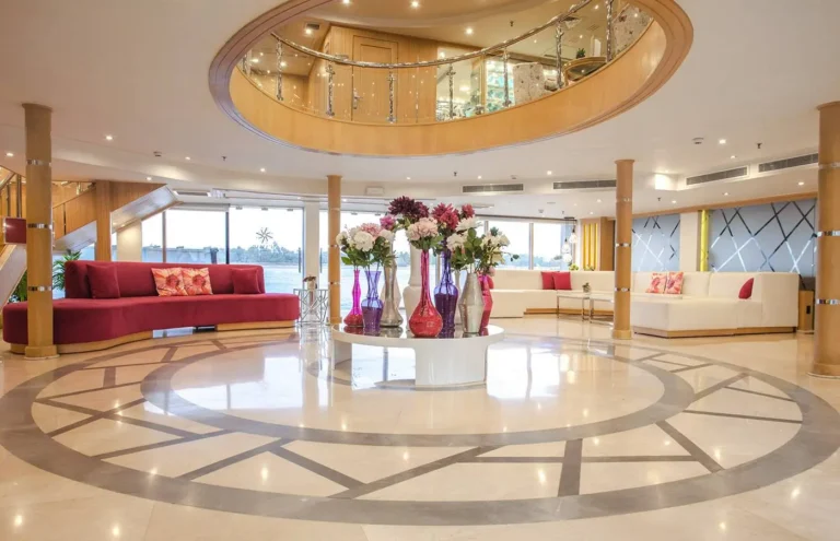 Acamar lobby with marble floor, flowers and red sofa
