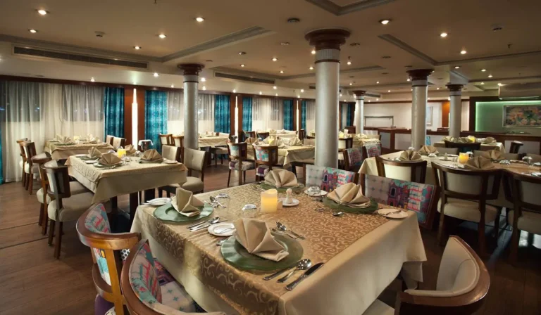 Acamar restaurant with columns and tables set for dinner