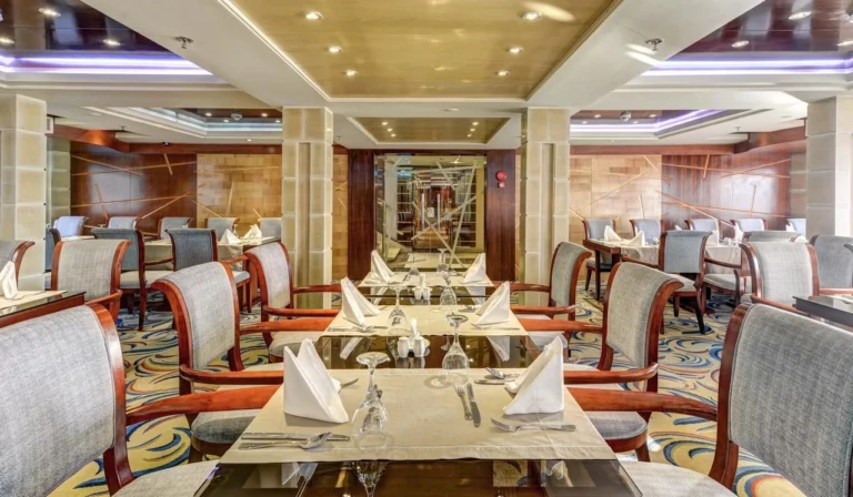 Esmeralda restaurant tables set with folded napkins