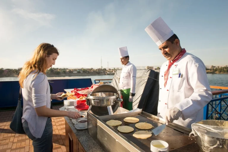 Chef cooking flatbread for a guest at the Esmeralda deck grill