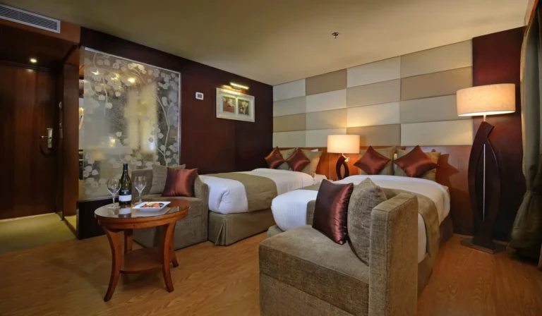 Twin cabin with armchair and side table on the Esmeralda