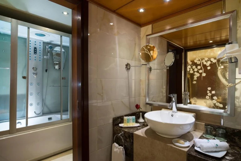 Esmeralda bathroom with vessel sink and shower cabin