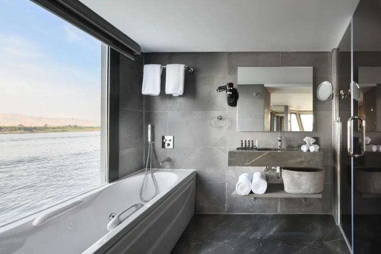 Bathtub beside a panoramic Nile window in a Historia bathroom