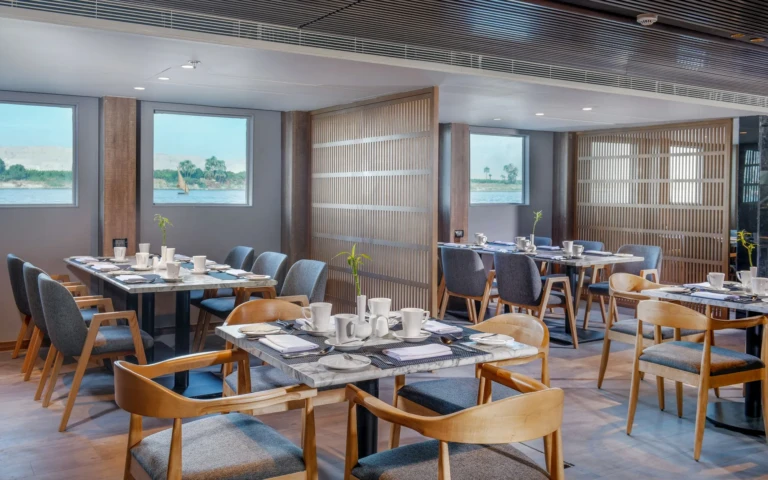 Historia restaurant tables set beside large river windows