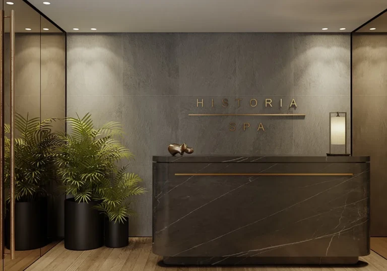 Historia reception desk with grey stone wall and plants