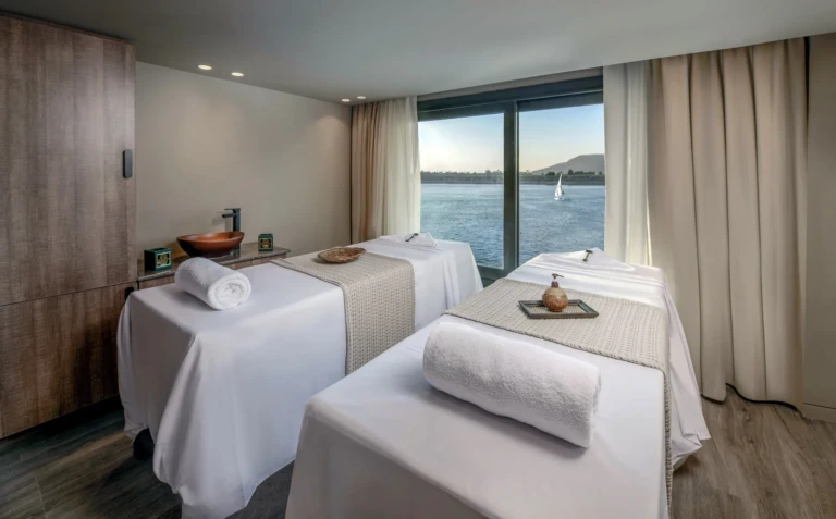 Twin massage beds facing a Nile window in the Historia spa