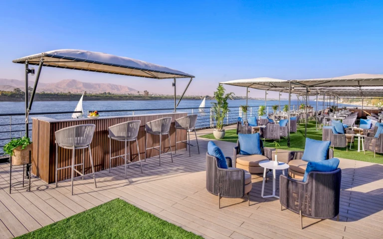 Outdoor bar with stools under a canopy on the Historia deck