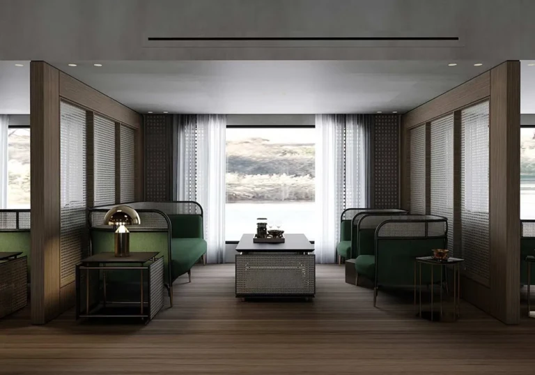 Green booth seating by a window in a Historia lounge
