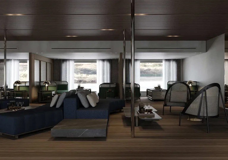 Lounge with dark sofas and tall windows on the Historia