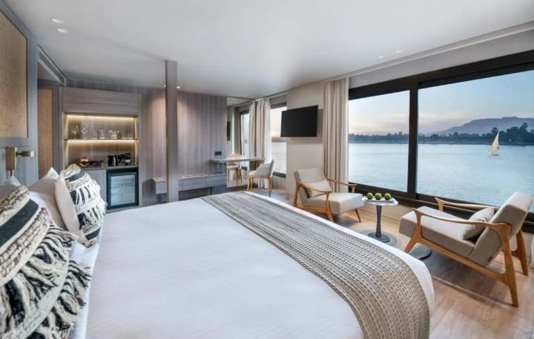King bed facing a Nile window with sailboat in a Historia suite