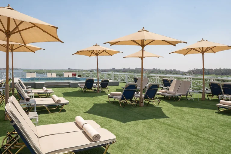Sun loungers under parasols on artificial grass deck