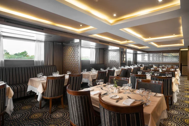 Restaurant with striped chairs and tables by windows