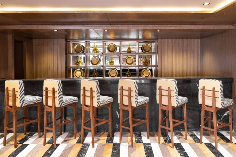 Jaz Viceroy bar counter with striped stools and display shelves