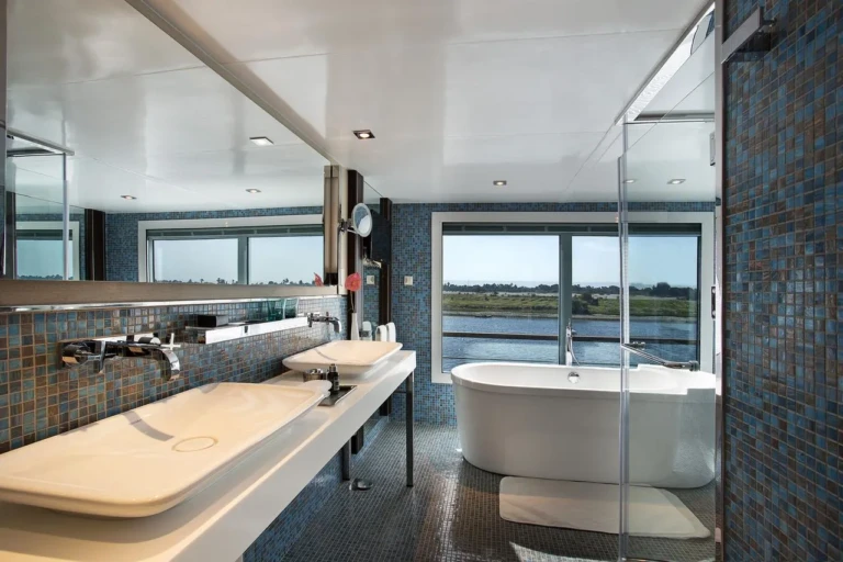 Bathroom with freestanding tub and double sinks by a Nile window