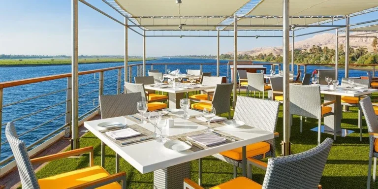 Open-air deck dining tables overlooking the Nile on Oberoi Philae