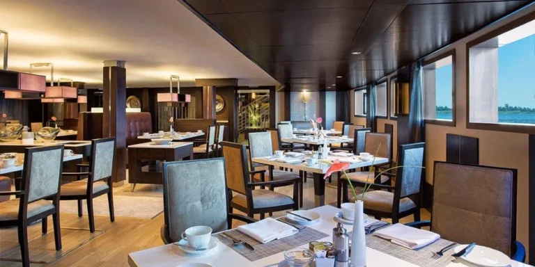 Oberoi Philae restaurant with set tables beside large windows