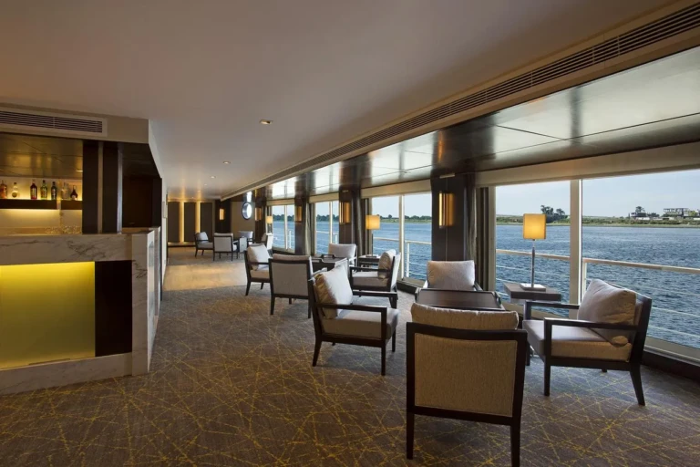 Oberoi Philae bar lounge with armchairs along Nile windows