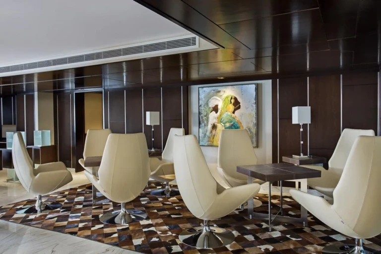 Oberoi Philae lounge with cream armchairs and cowhide rug