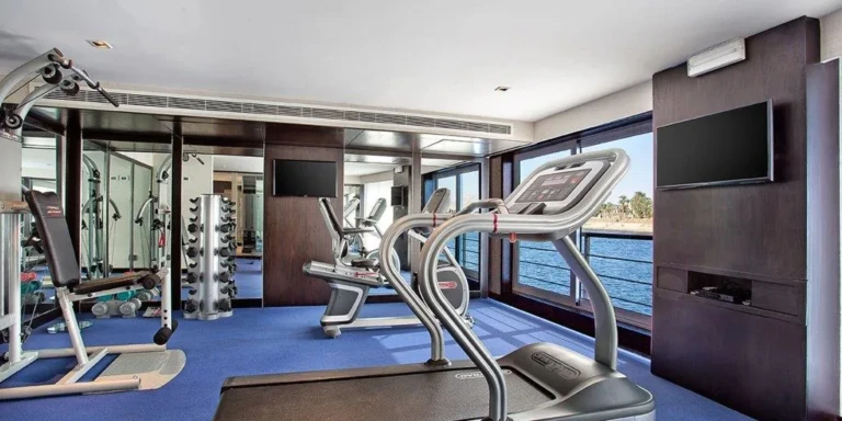 Oberoi Philae gym with treadmill and weights by river windows