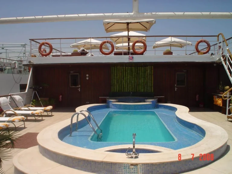 Sun deck swimming pool with loungers on MS Alexander the Great