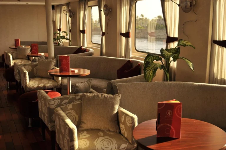 Lounge with armchairs and river windows on MS Alexander the Great