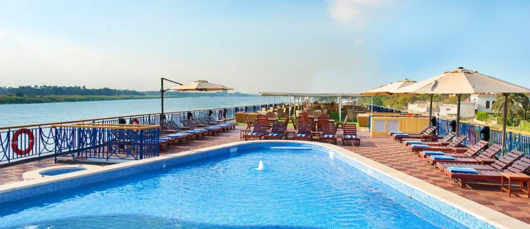 Amwaj Living Stone pool and sunbeds with umbrellas