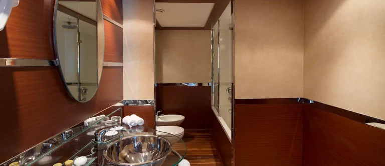 Amwaj Living Stone bathroom with steel basin, toilet and bidet