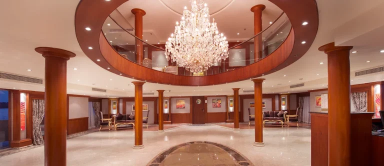 Amwaj Living Stone reception hall with chandelier and columns