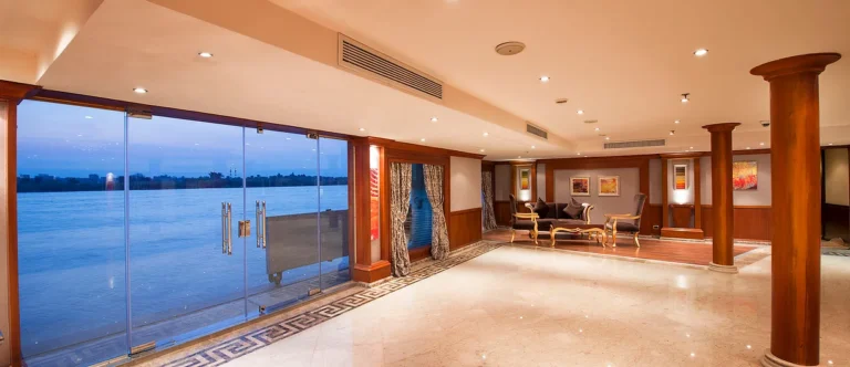 Amwaj Living Stone lobby with floor-to-ceiling Nile windows at dusk