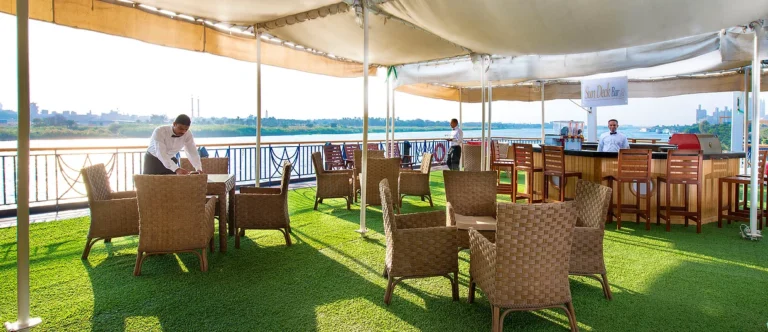 Shaded sun deck with wicker chairs on the Amwaj Living Stone