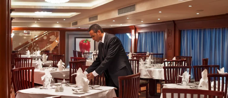 Waiter setting tables in the Amwaj Living Stone restaurant