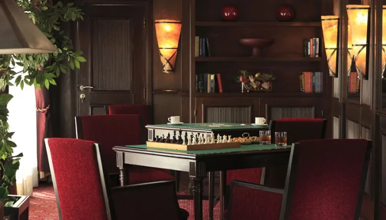 Games corner with chess table and red chairs on MS Jaz Senator