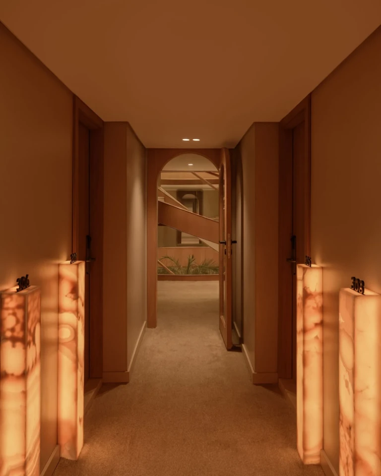 Corridor lit by alabaster floor lamps leading to cabins on Le Fayan