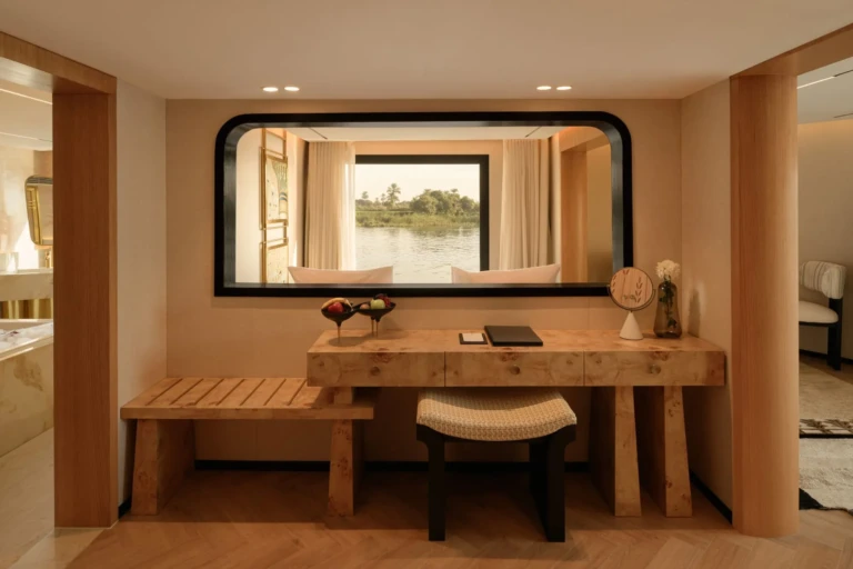 Vanity desk and bench below a mirror reflecting the Nile on Le Fayan