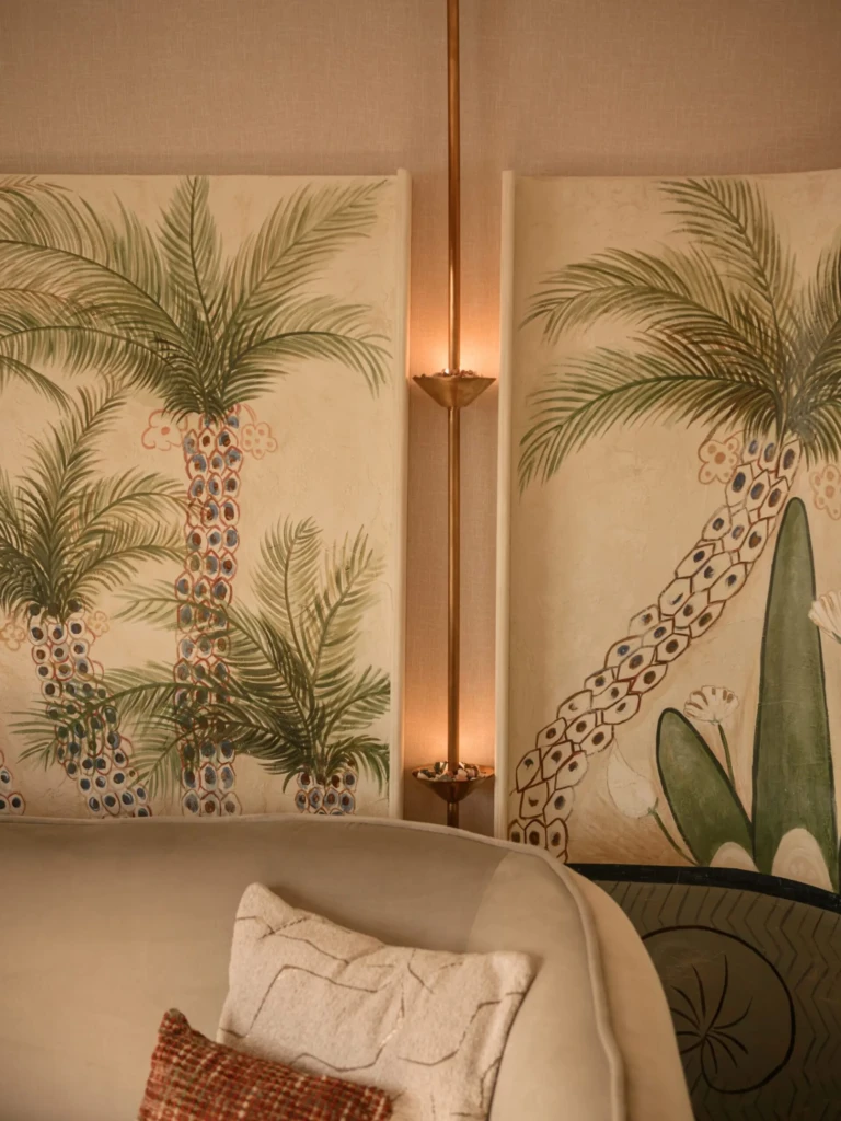 Palm tree wall panels behind a sofa in a Le Fayan suite
