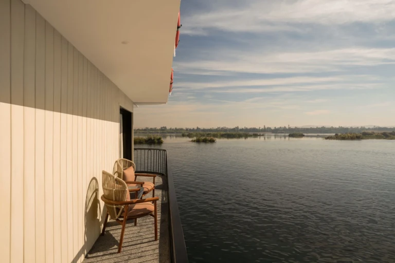 Private balcony with two chairs overlooking the Nile on Le Fayan