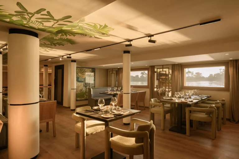 Dining tables by panoramic windows in the Le Fayan restaurant
