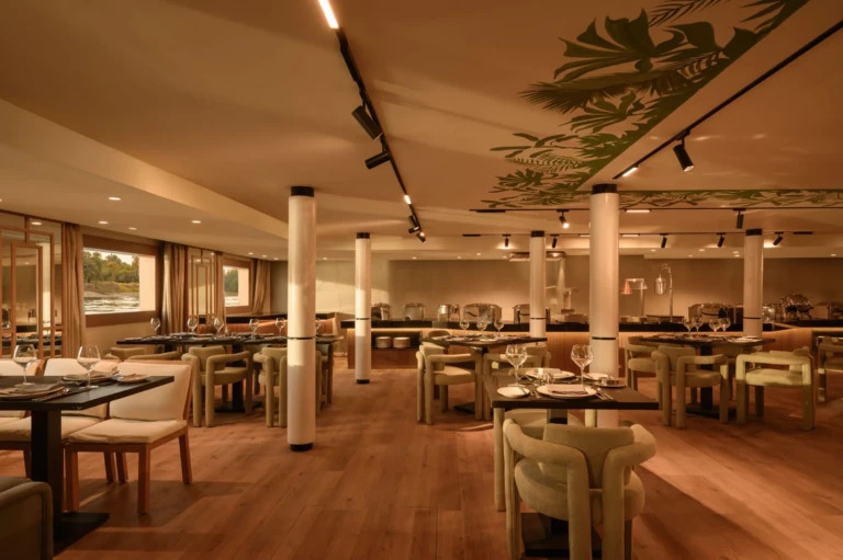 Le Fayan main restaurant with white columns and leaf ceiling mural