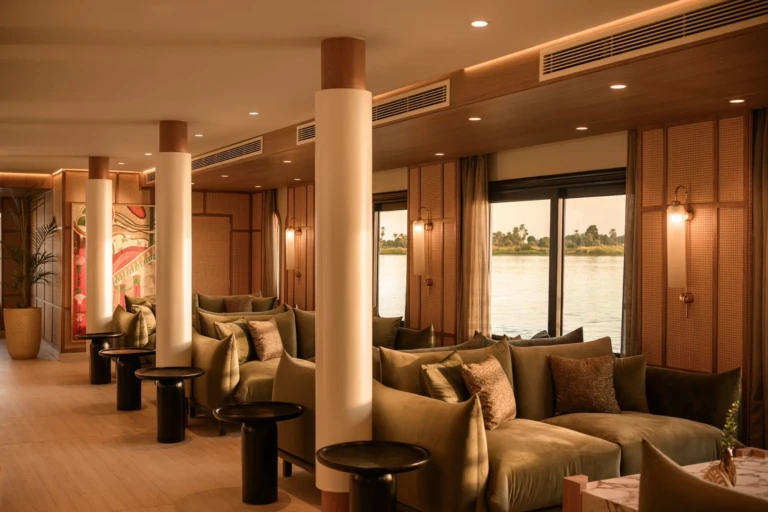 Le Fayan lounge with green sofas, columns and Nile windows