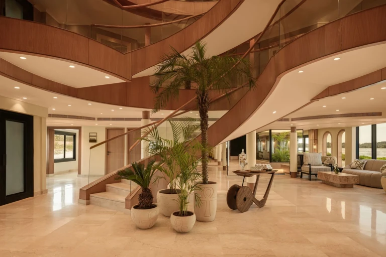 Grand staircase and lobby seating area aboard Le Fayan