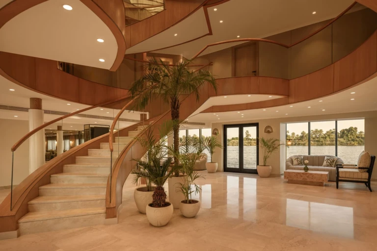 Le Fayan lobby with spiral staircase, potted palms and river view