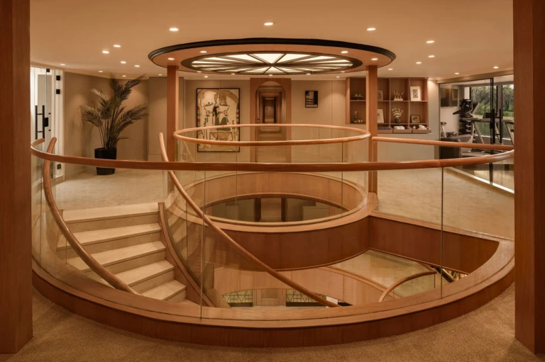 Le Fayan atrium with curved staircase and glass railings