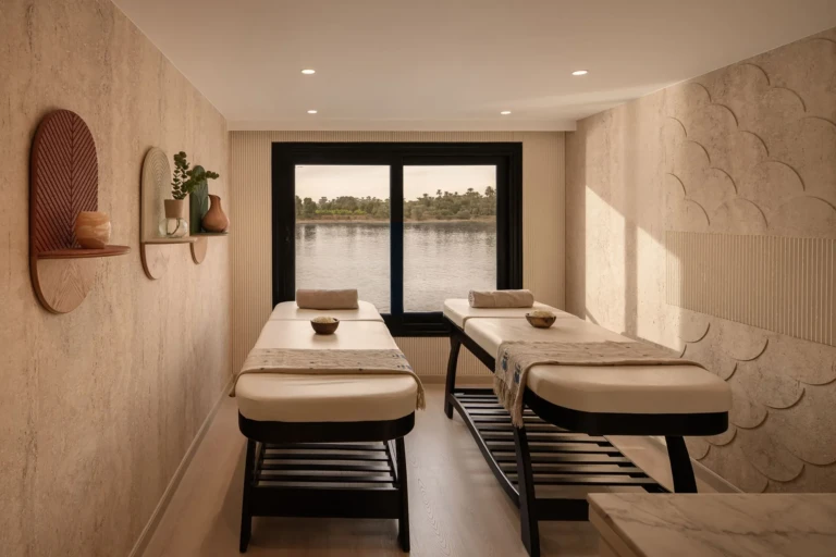 Le Fayan spa room with two massage tables and Nile window