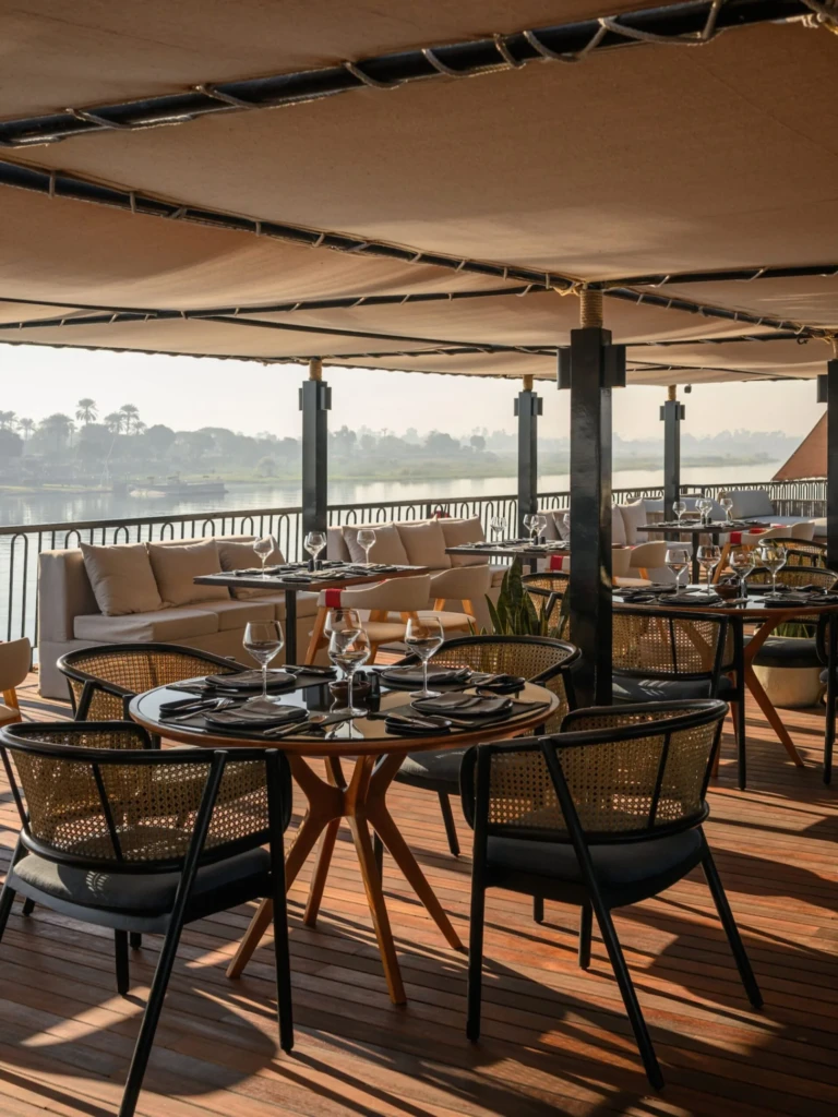Shaded outdoor dining tables on Le Fayan deck overlooking the Nile