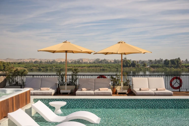 Pool with parasols and sun loungers overlooking the Nile on Le Fayan