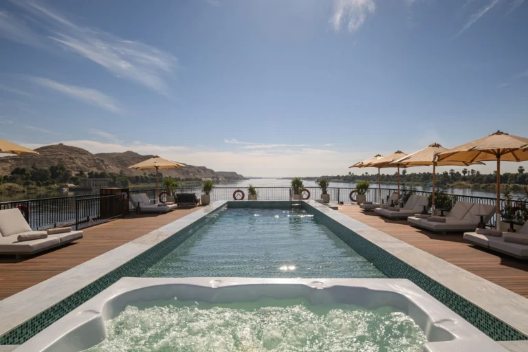 Le Fayan pool and jacuzzi with sun loungers and parasols